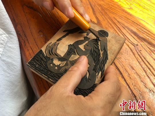 图为甘肃艺人徐晋林正在雕刻创作。　徐雪 摄